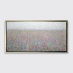 A green and purple abstract landscape print in a silver floater frame hangs on a white wall.