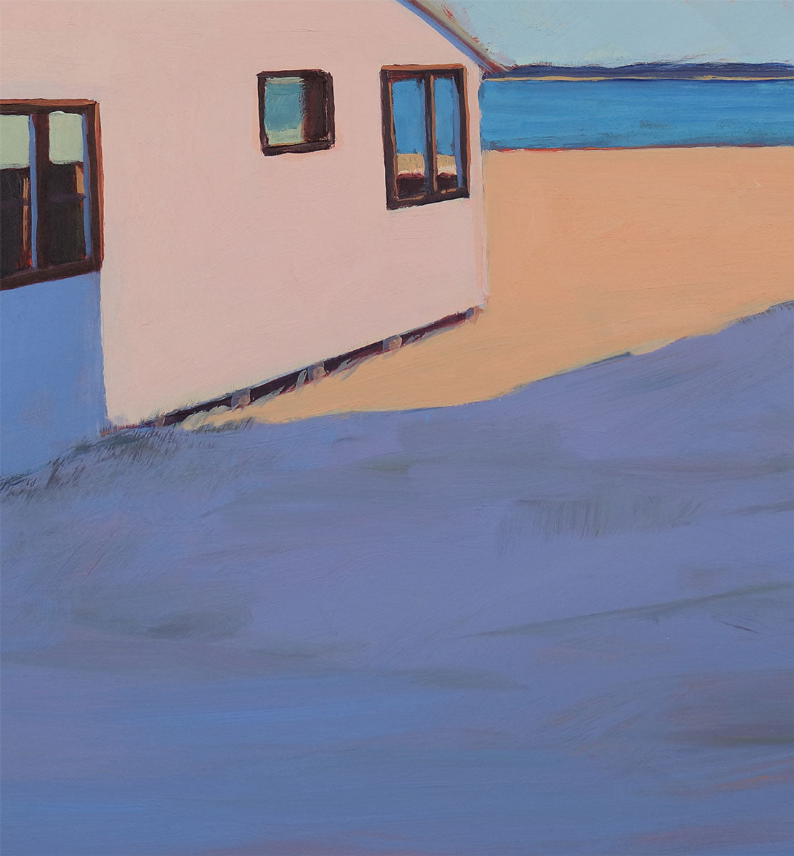 Close up of the dark blue shadow of the other beach house, the sunlit beach and the water in the background.