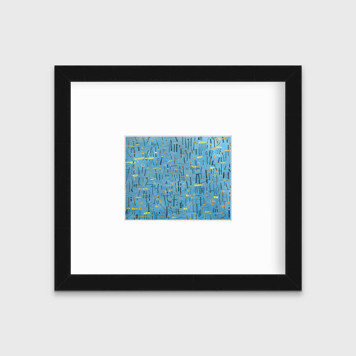 A blue, yellow and orange abstract print in a black frame with a mat hangs on a white wall.