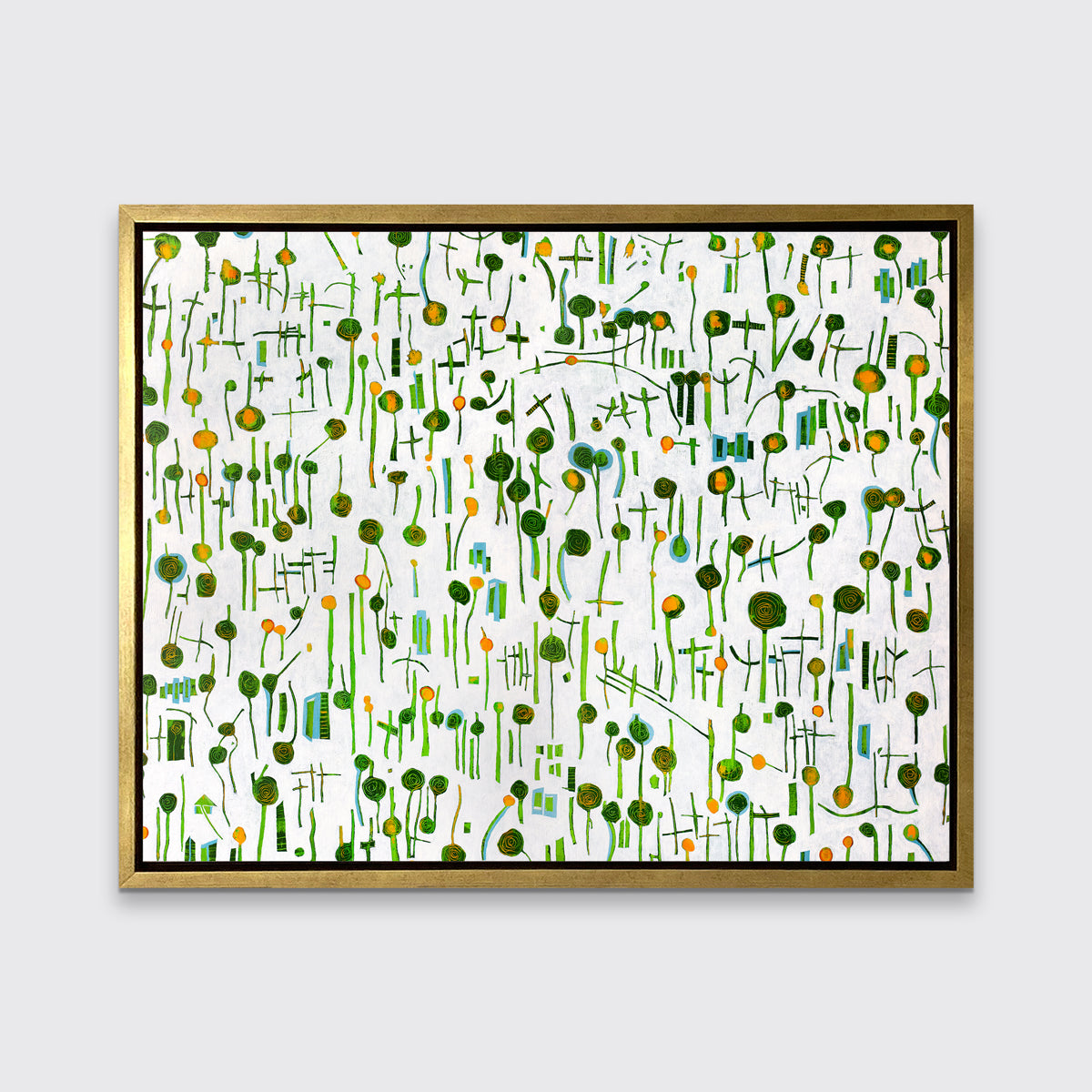 A green, yellow and white abstract print in a gold floater frame hangs on a white wall.