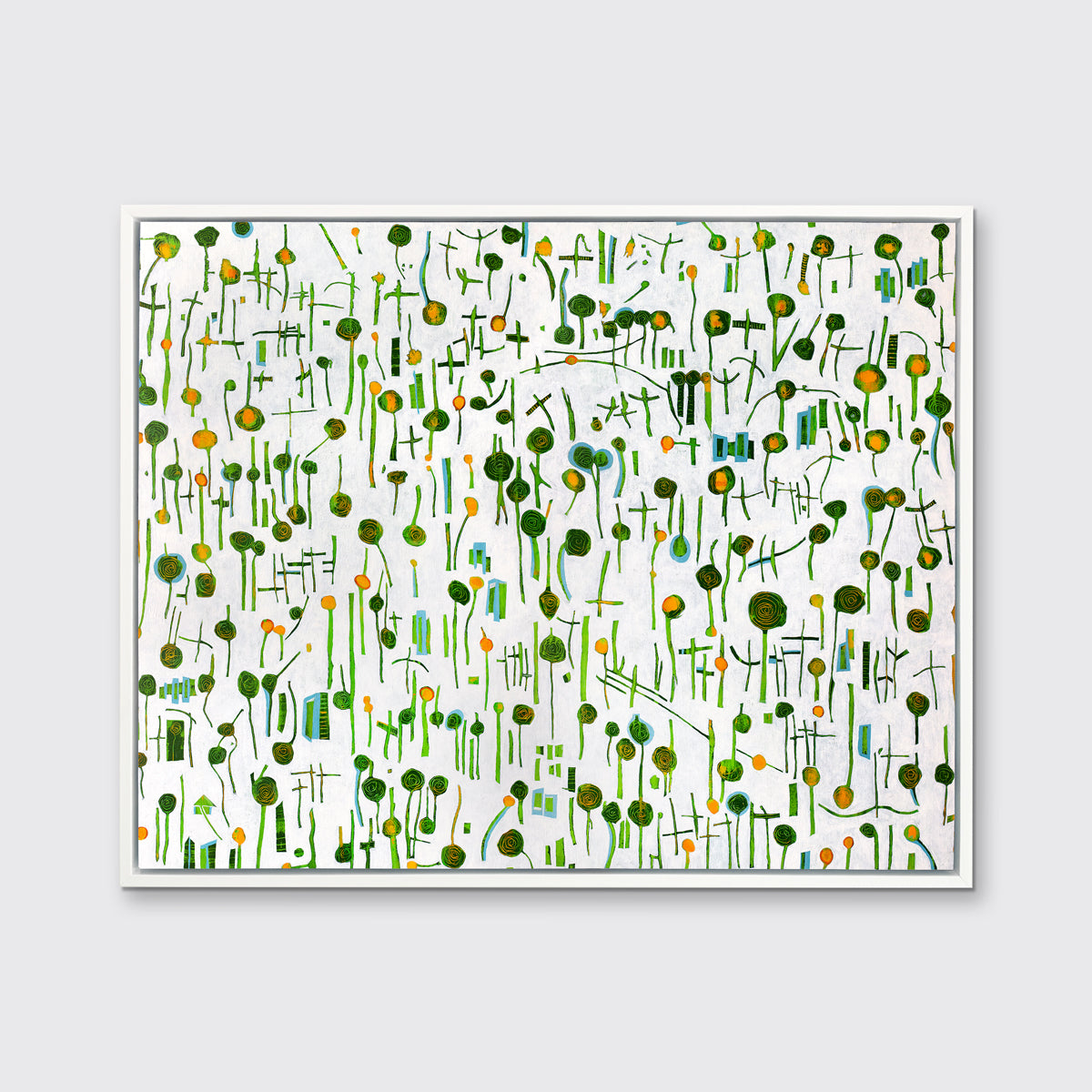 A green, yellow and white abstract print in a white floater frame hangs on a white wall.