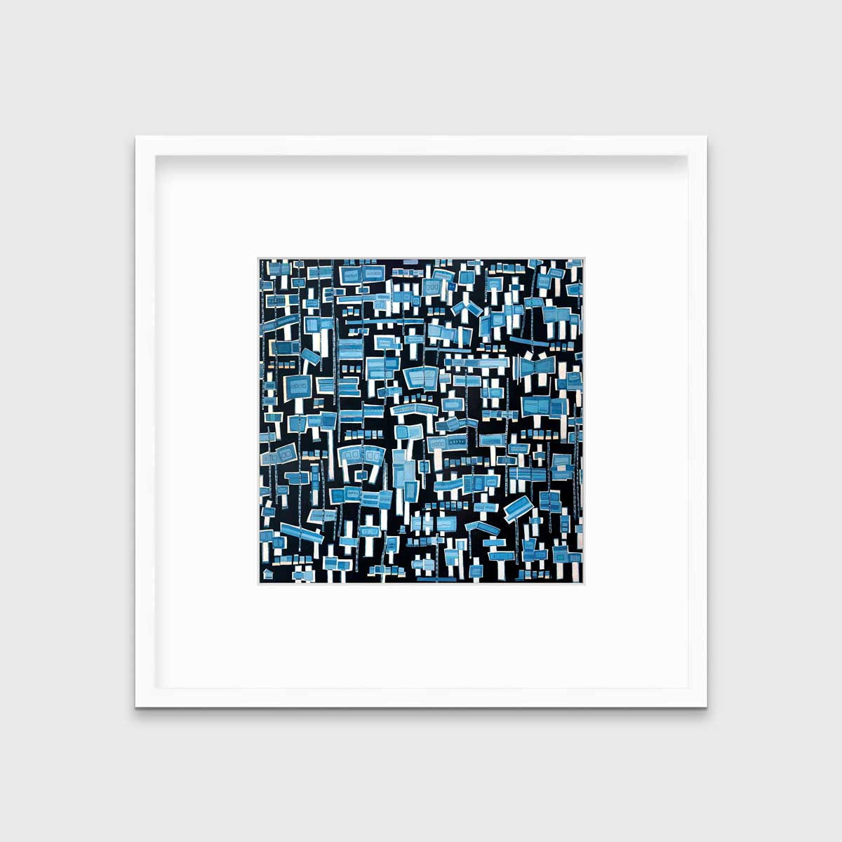 A blue, white and black abstract print in a white frame with a mat hangs on a white wall.