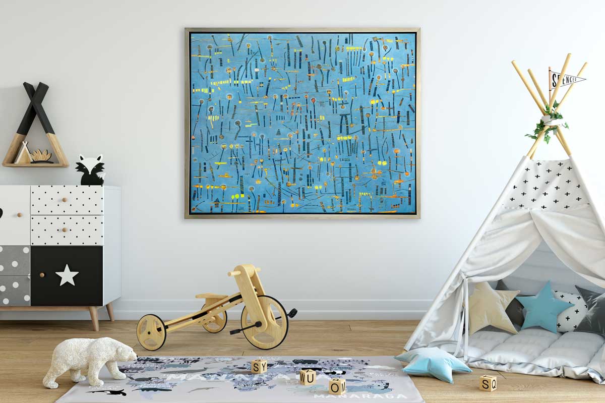 A blue, yellow and orange abstract print in a silver floater frame hangs on a white wall above a children's playroom with a white tent, a play mat, a wooden tricycle and a white and black dresser.