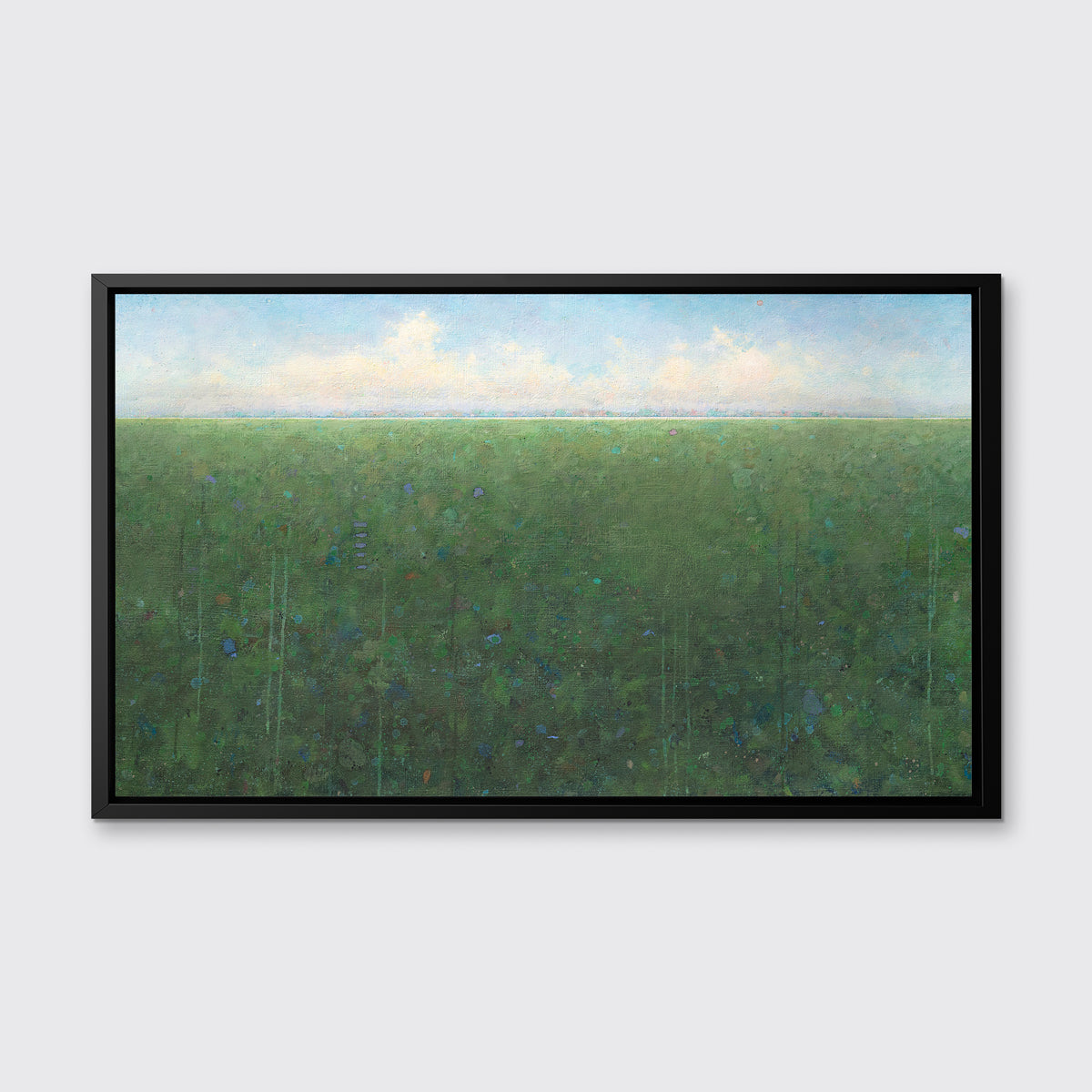 A green, light blue and white abstract landscape print in a black floater frame hangs on a white wall.