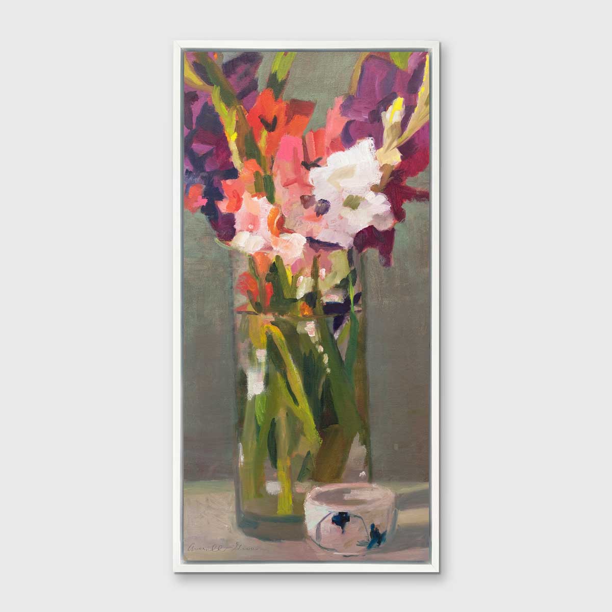 A purple, pink and green abstract floral print in a white floater frame hangs on a white wall.