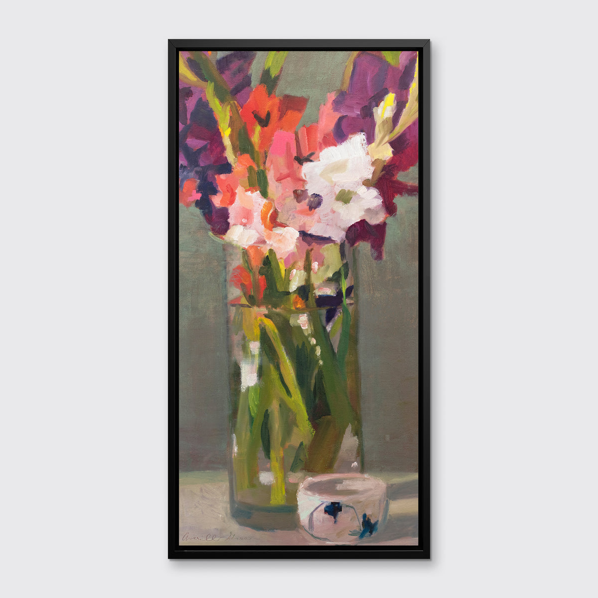 A purple, pink and green abstract floral print in a black floater frame hangs on a white wall.