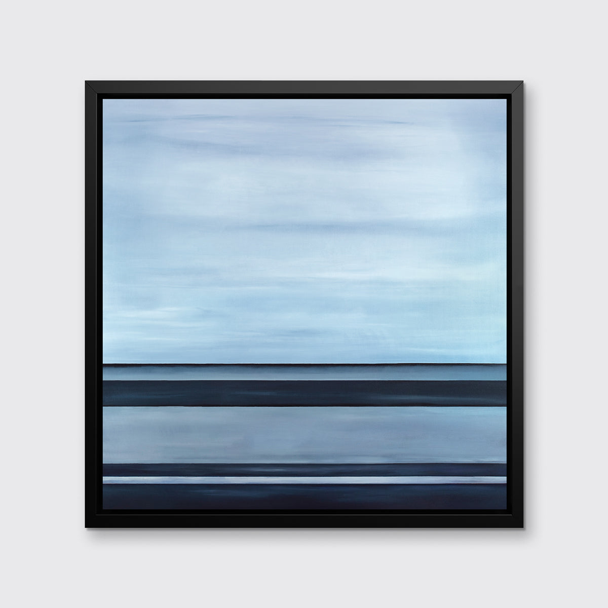 A tonal blue linear abstract print in a black floater frame hangs on a white wall.