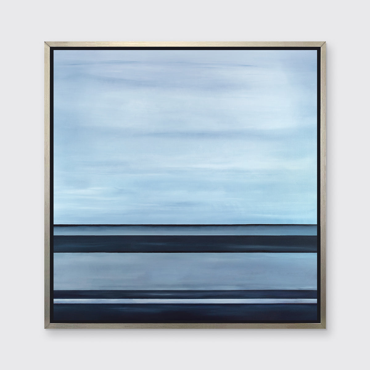 A tonal blue linear abstract print in a silver floater frame hangs on a white wall.