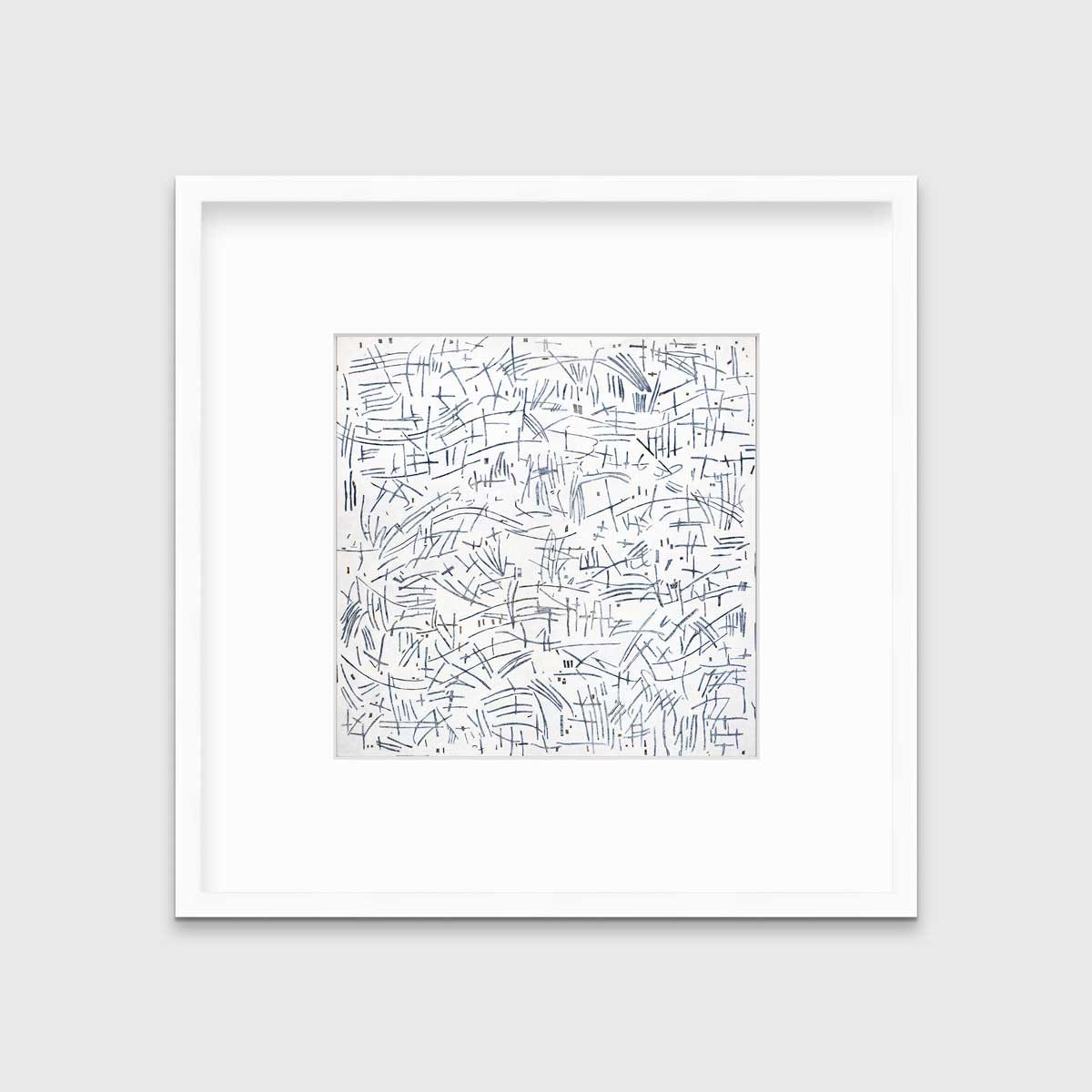 A white and blue abstract print in a white frame with a mat hangs on a white wall.