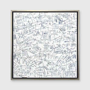 A white and blue abstract print in a silver floater frame hangs on a white wall.