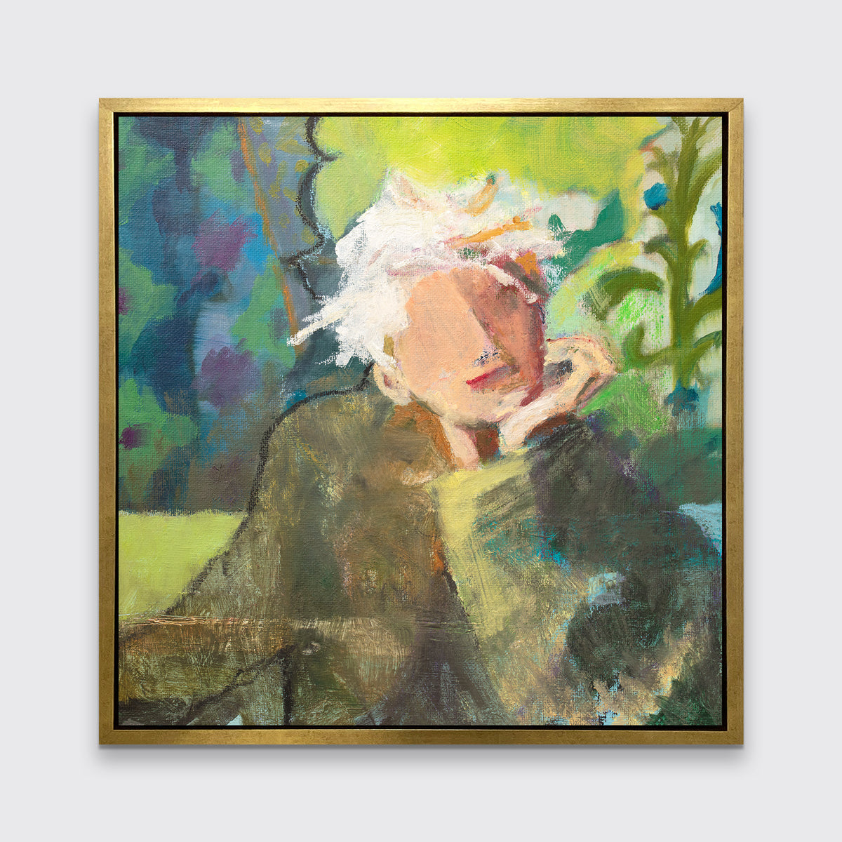 A green, beige and white abstract figural print in a gold floater frame hangs on a white wall.