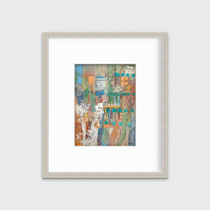 An abstract multicolored print in a silver frame with a mat hangs on a white wall.