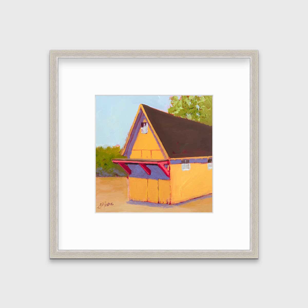 A yellow, orange, lavender and blue contemporary barn print in a silver frame with a mat hangs on a white wall.
