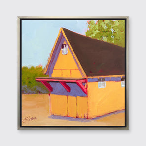 A yellow, orange, lavender and blue contemporary barn print in a silver floater frame hangs on a white wall.