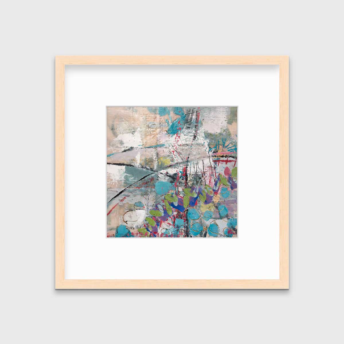 A turquoise, green, beige and pink abstract print in a natural wood frame with a mat hangs on a white wall.