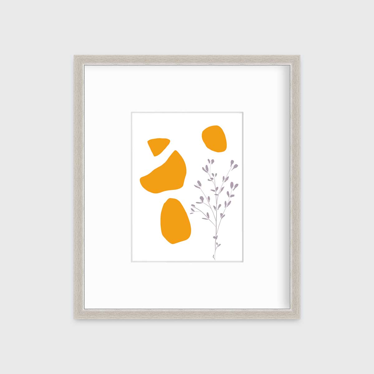 A minimal abstract print of a lavender wildflower with orange geometric shapes by Hazal Ozturk in a silver frame with a mat hangs on a white wall.