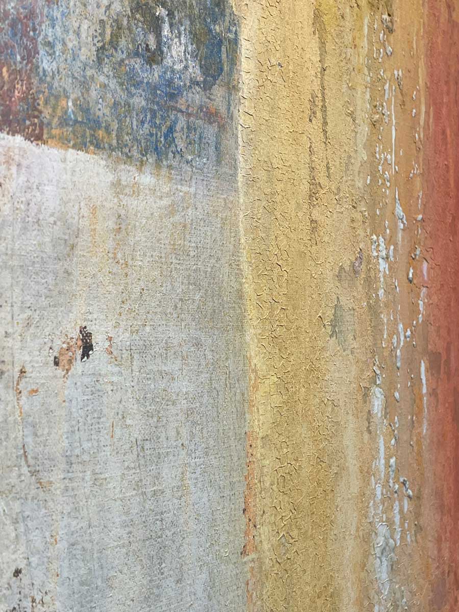 A close up of the texture of the white, blue and yellow paint.