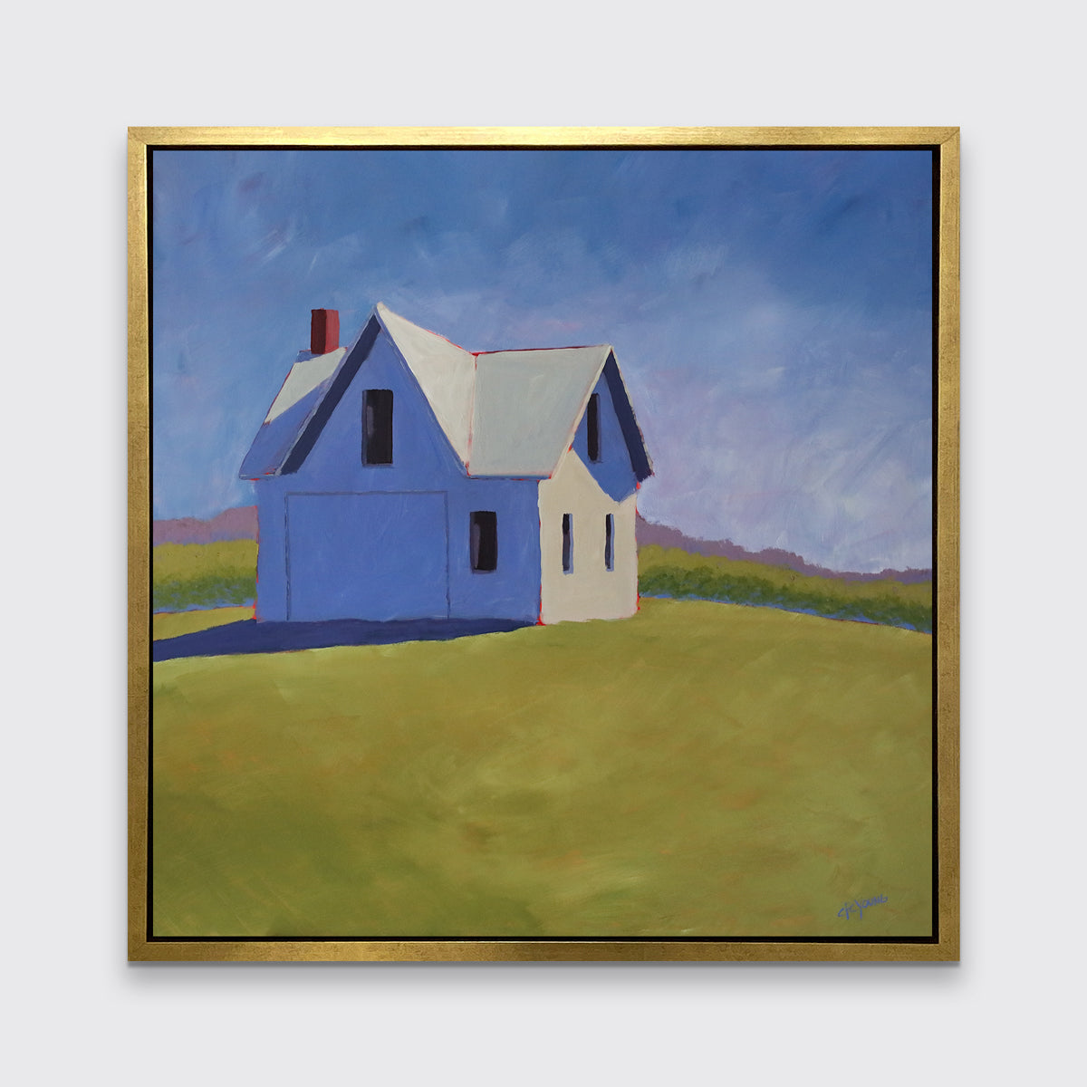 A blue and green contemporary barn print in a gold floater frame hangs on a white wall.