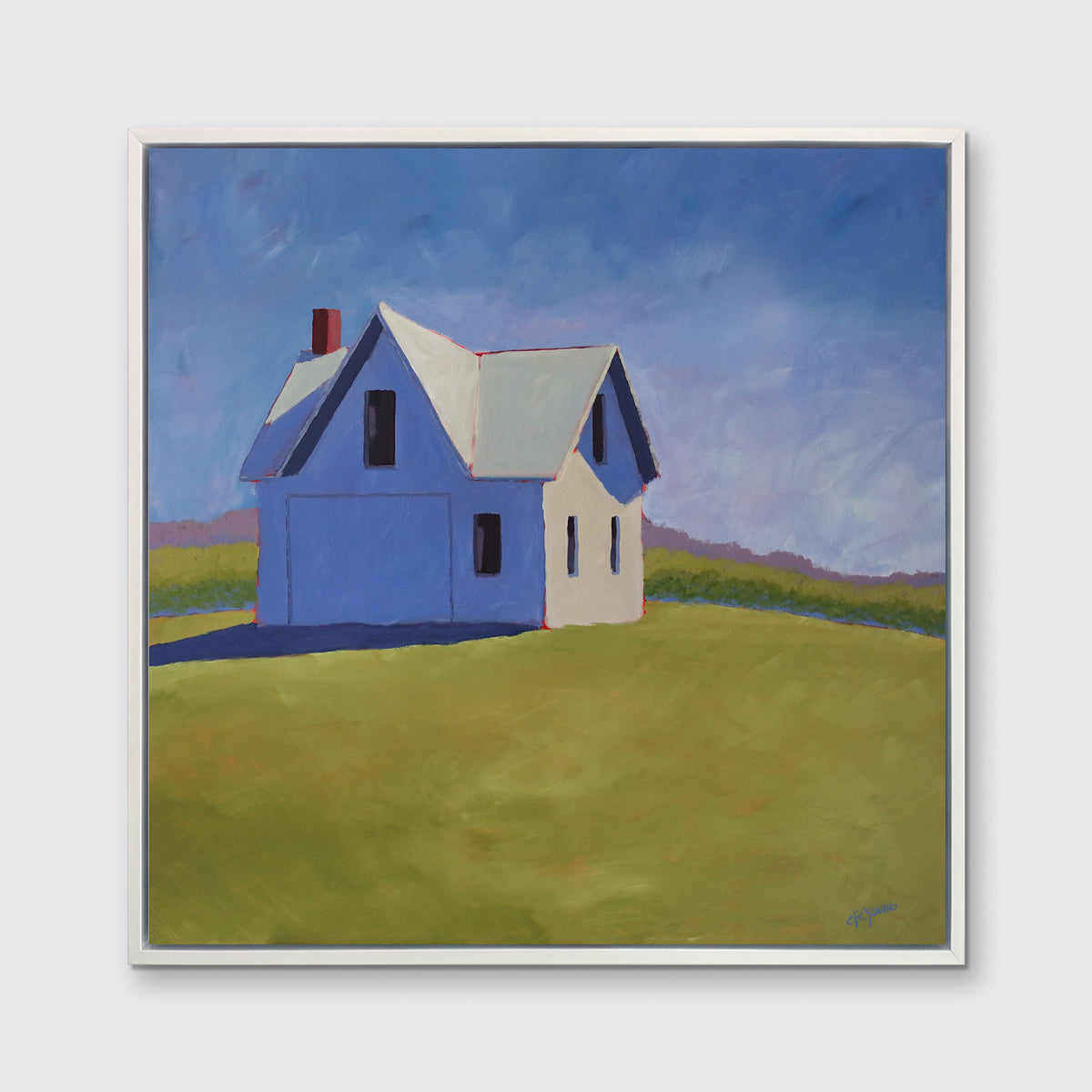 A blue and green contemporary barn print in a white floater frame hangs on a white wall.
