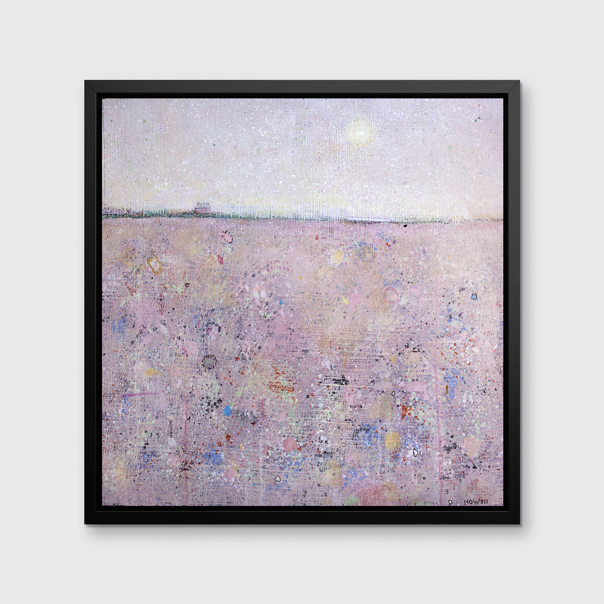 A pink abstract landscape print in a black floater frame hangs on a white wall.