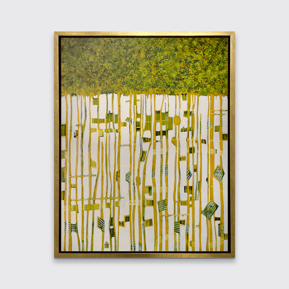 A green, yellow and white abstract print in a gold floater frame hangs on a white wall.