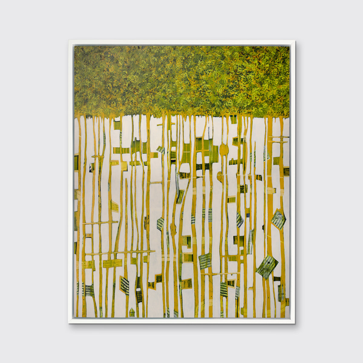 A green, yellow and white abstract print in a white floater frame hangs on a white wall.