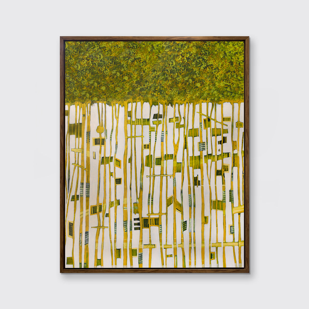 A green, yellow and white abstract print in an oak wood floater frame hangs on a white wall.