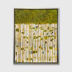 A green, yellow and white abstract print in a silver floater frame hangs on a white wall.