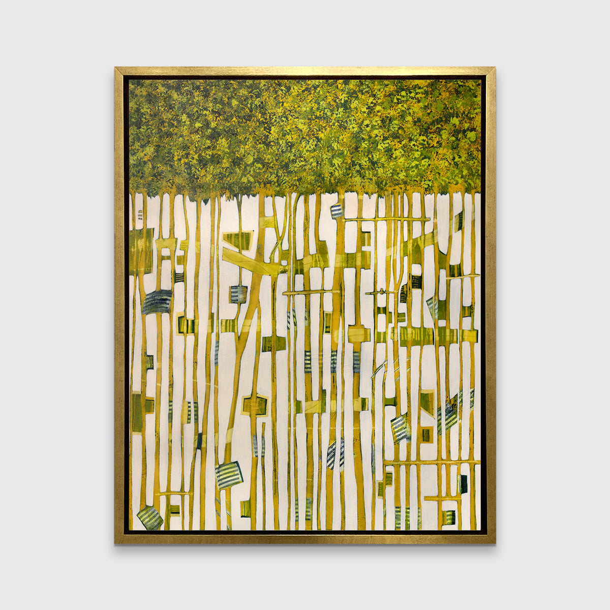 A green, yellow and white abstract print in a gold floater frame hangs on a white wall.