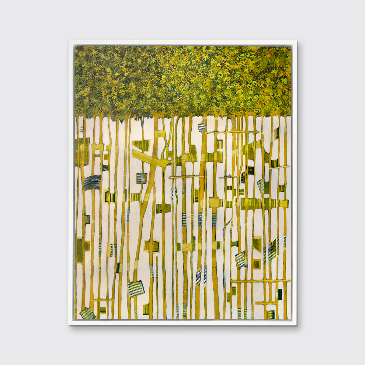 A green, yellow and white abstract print in a white floater frame hangs on a white wall.