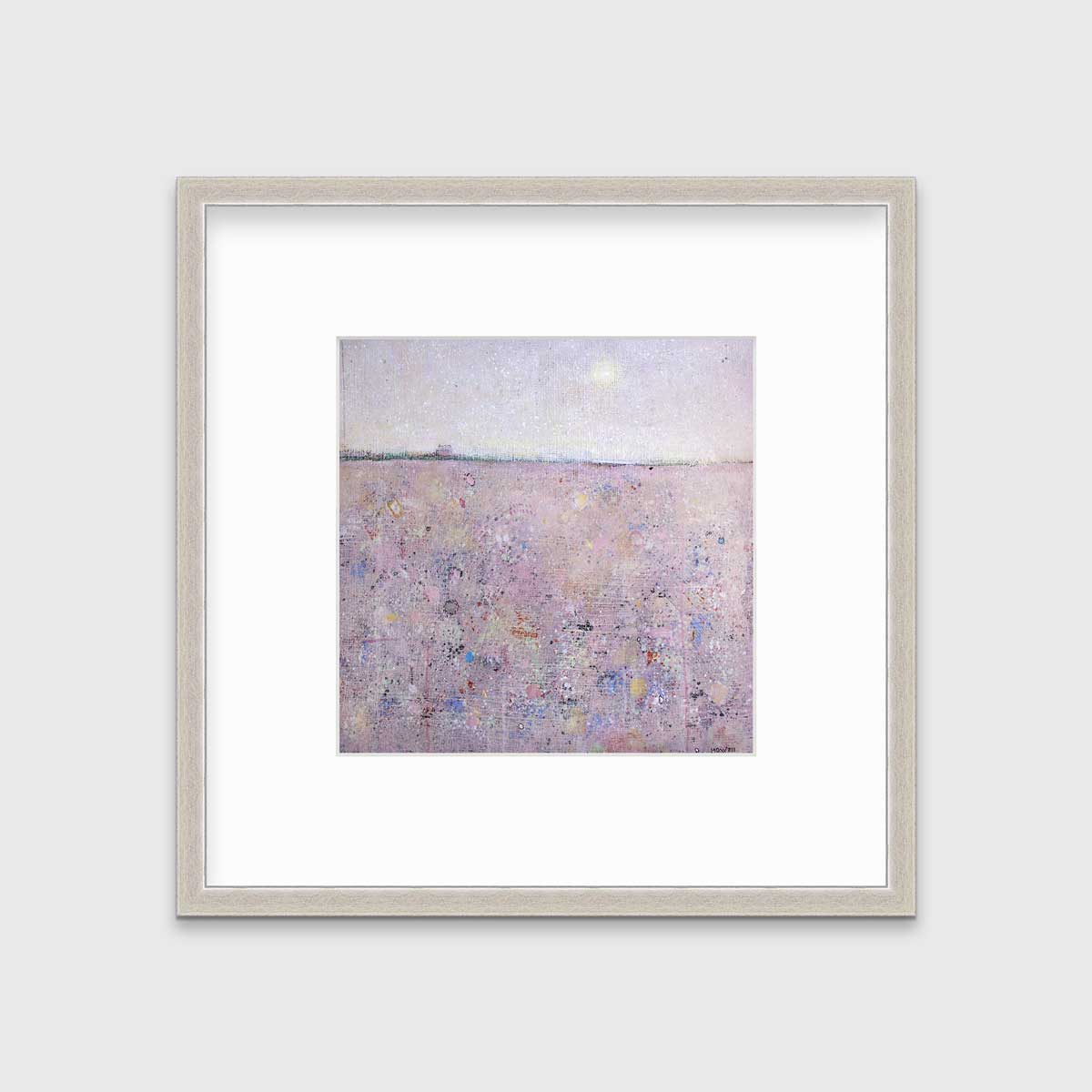 A pink abstract landscape print in a silver frame with a mat hangs on a white wall.