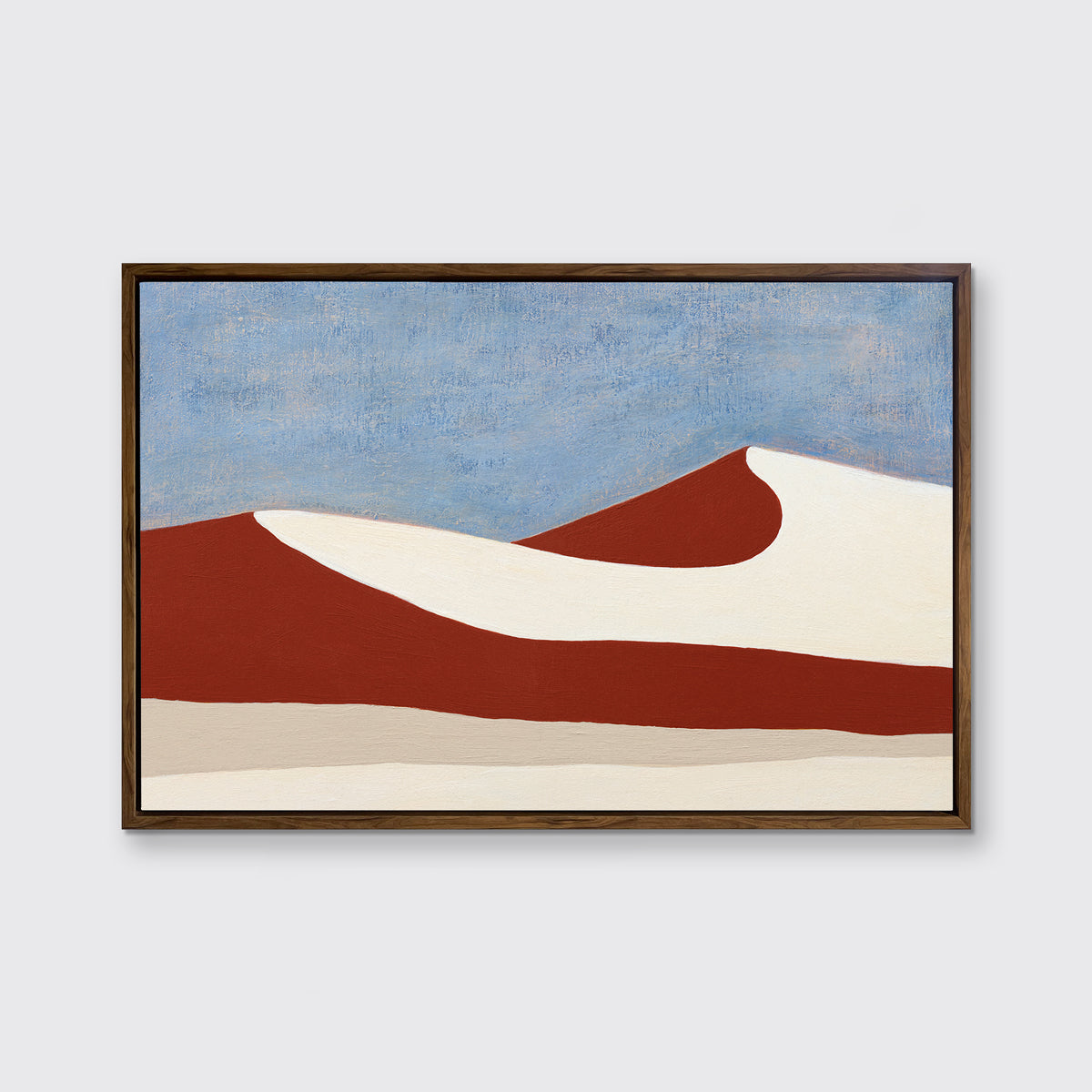 A blue, red and beige abstract landscape print in an oak wood floater frame hangs on a white wall.