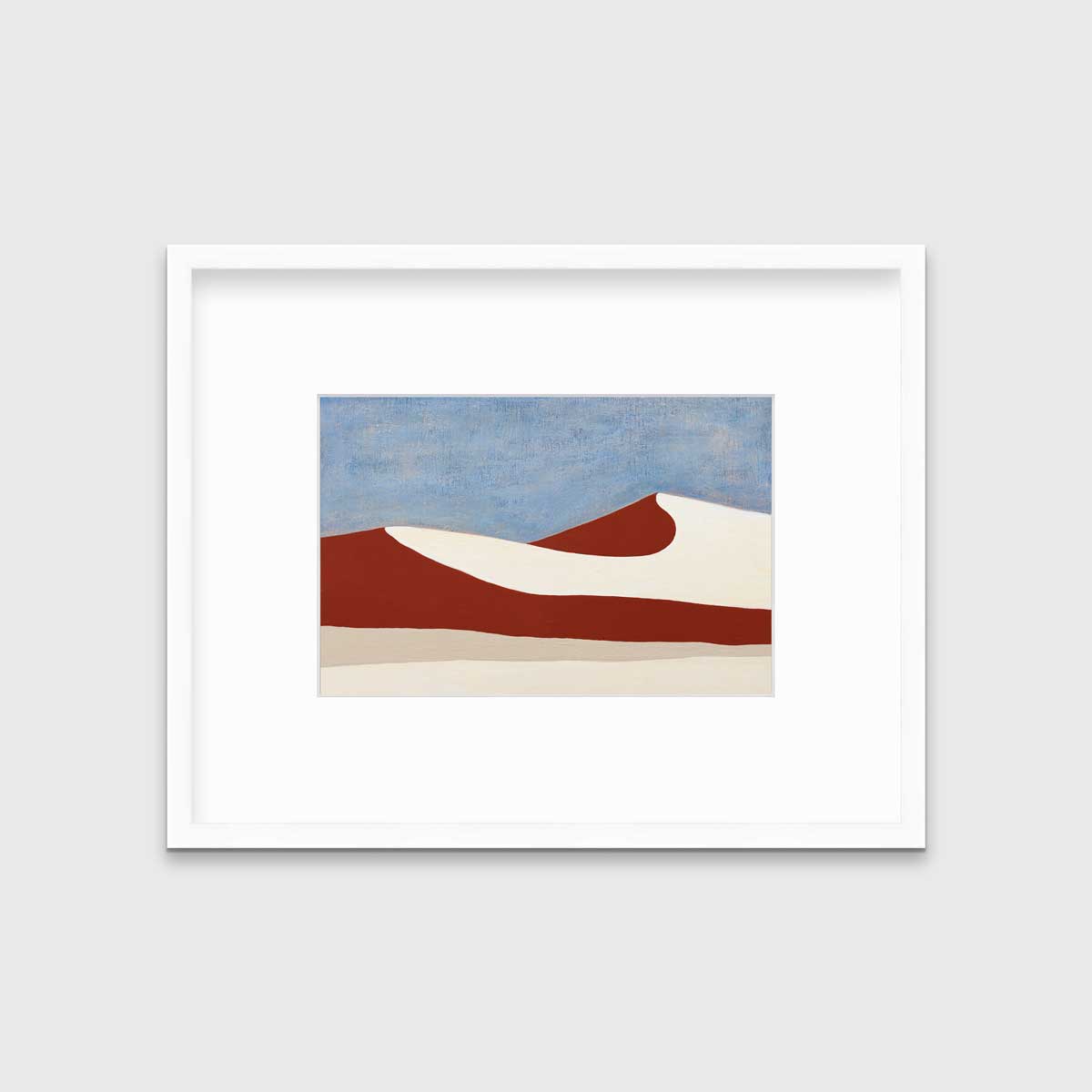 A blue, red and beige abstract landscape print in a white frame with a mat hangs on a white wall.