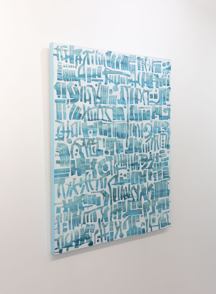 An abstract painting of azure cuneiform forms is seen at an angle on a gallery wall.