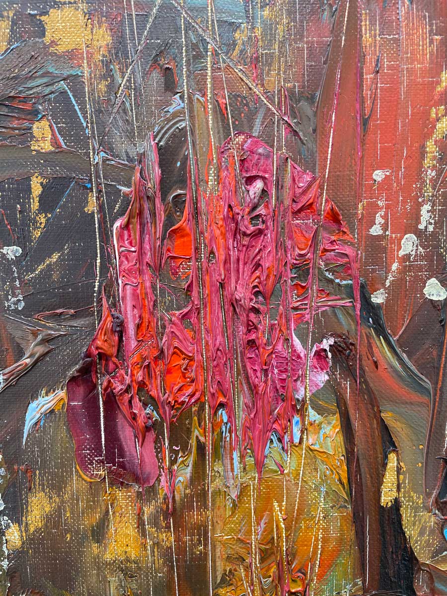 A close up of the texture of pink and red-orange paint.