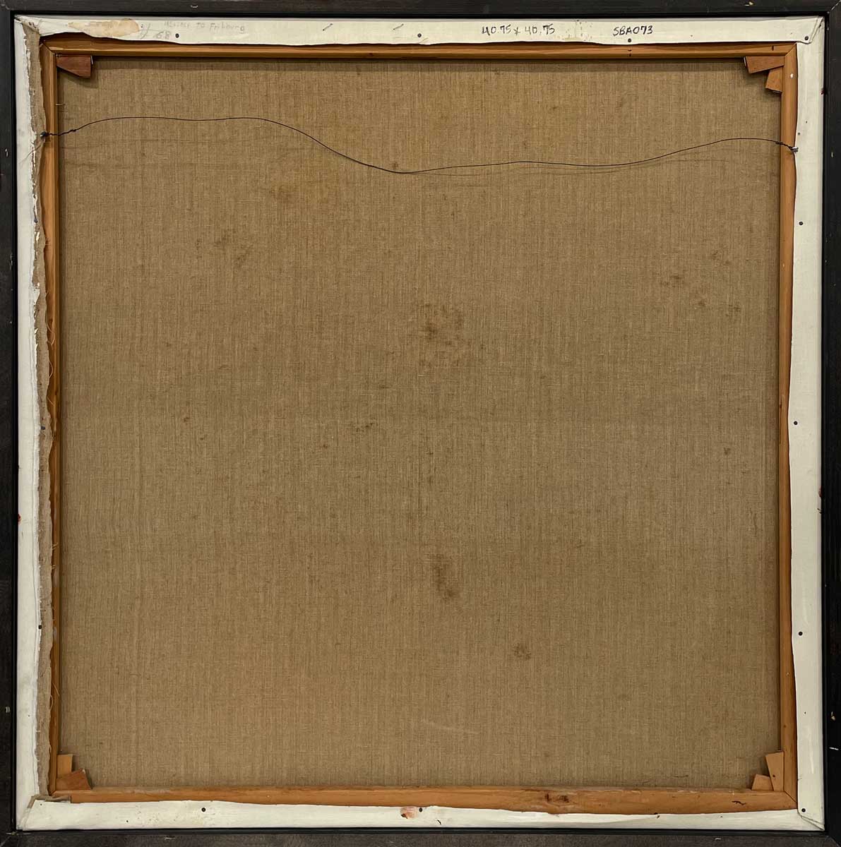 The back of the painting with the title and the hanging wire.