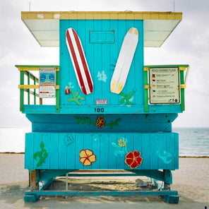 A rear view photograph of a turquoise, green, and yellow lifeguard stand in Miami, Florida.