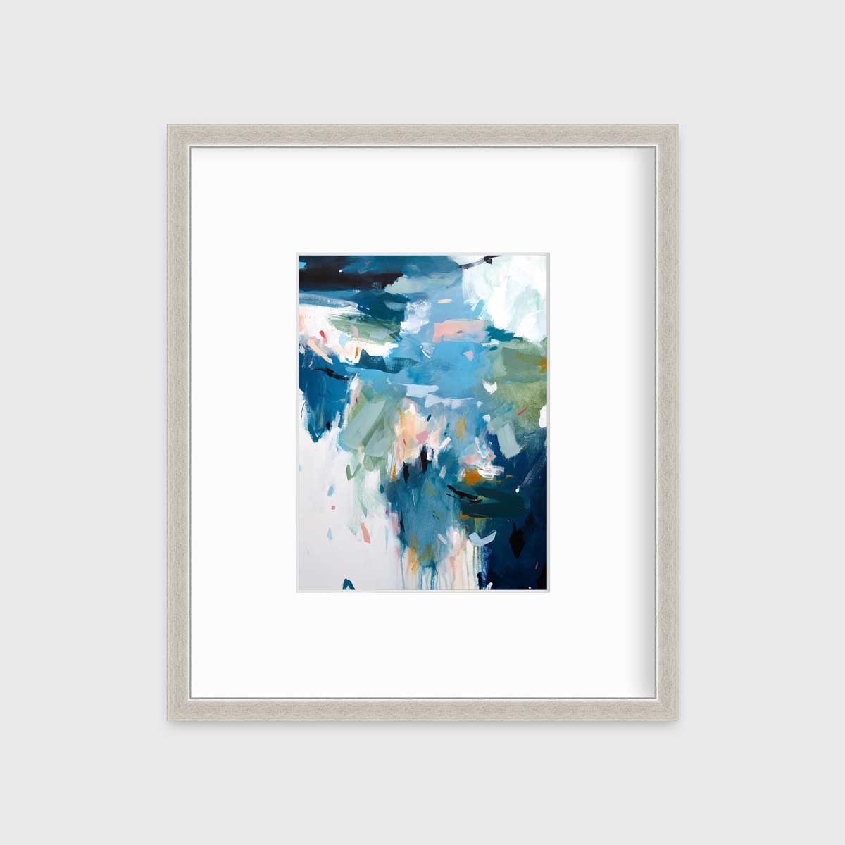 A blue abstract print by Kelly Rossetti in a silver frame with a mat hangs on a white wall.