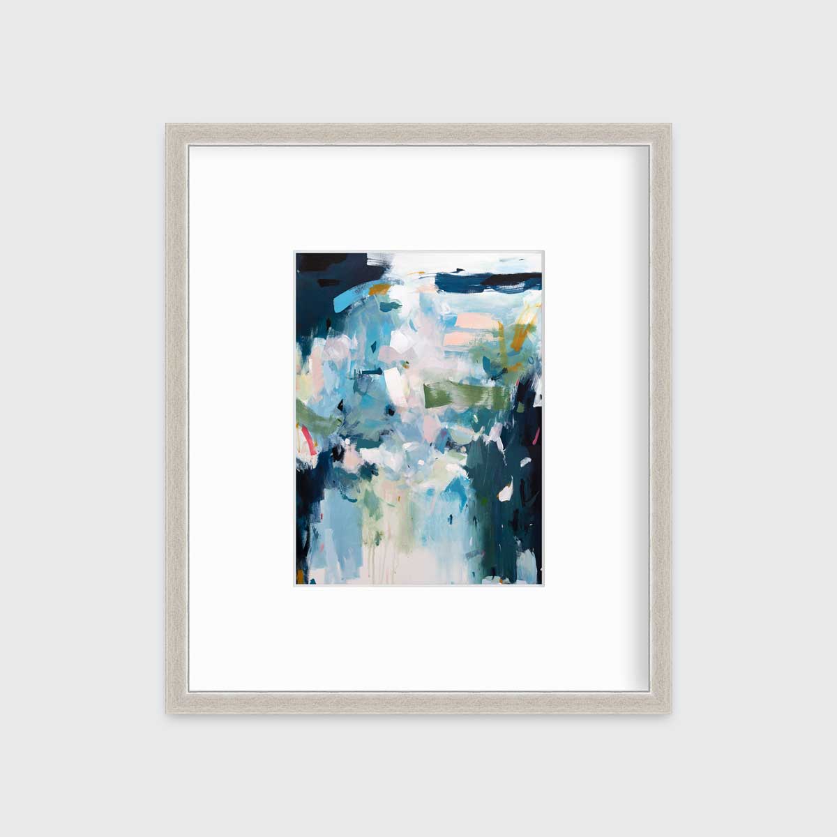 A blue abstract print by Kelly Rossetti in a silver frame with a mat hangs on a white wall.