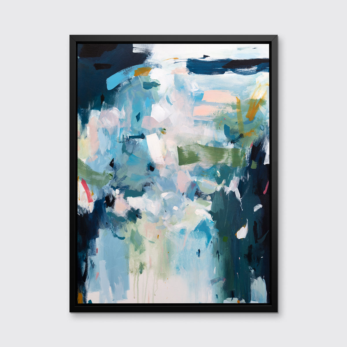 A blue, white and green abstract print in a black floater frame hangs on a white wall.