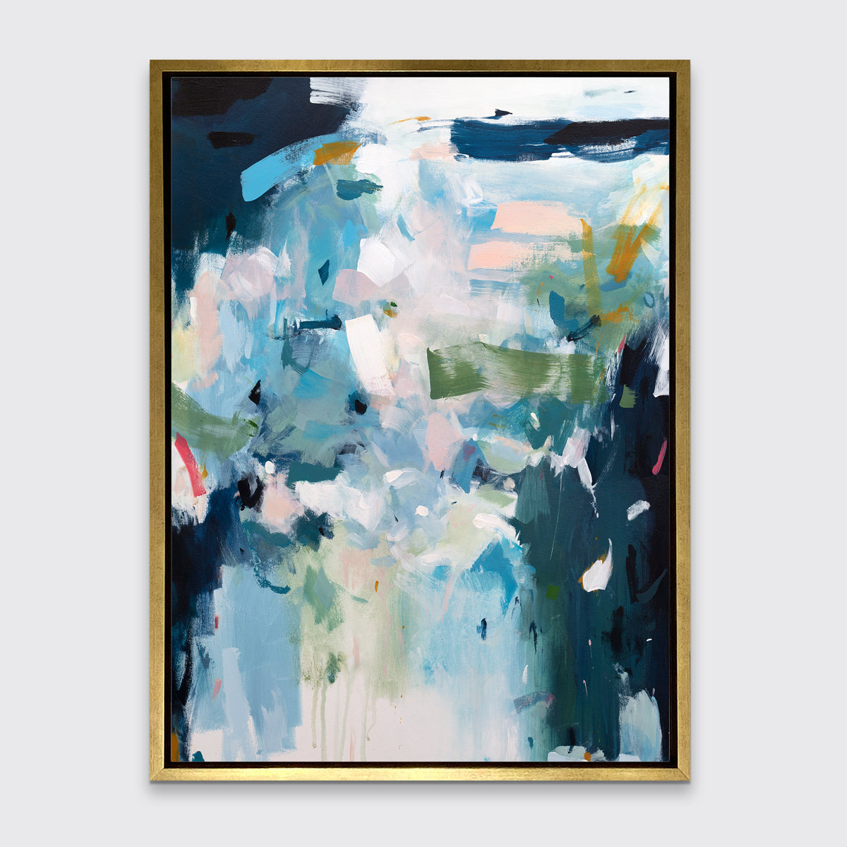 A blue, white and green abstract print in a gold floater frame hangs on a white wall.