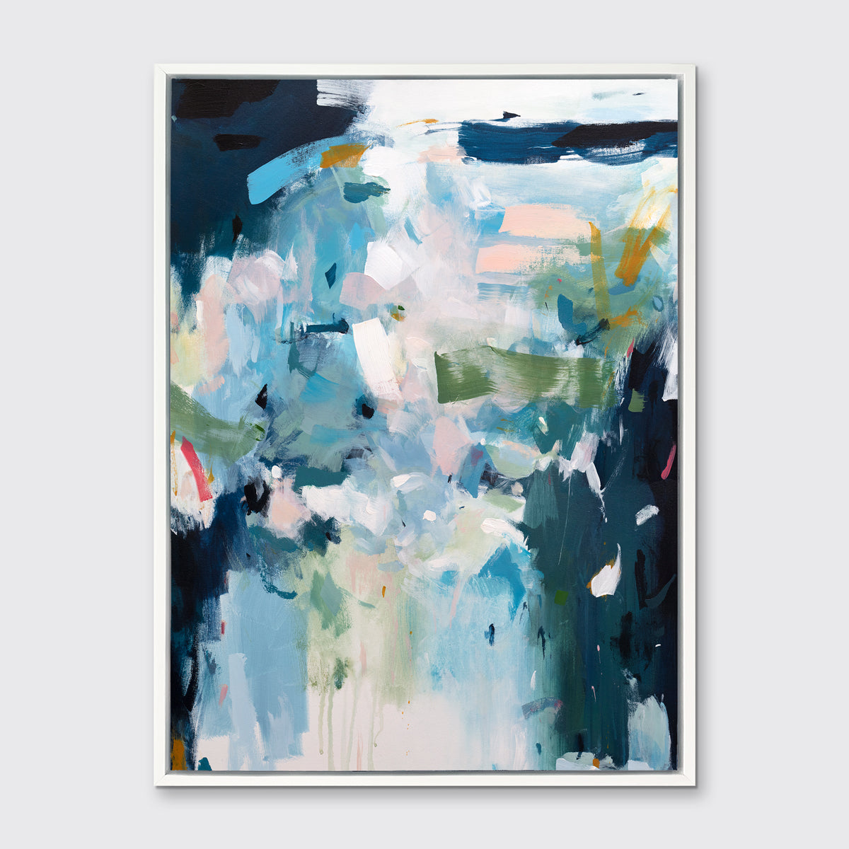 A blue, white and green abstract print in a white floater frame hangs on a white wall.