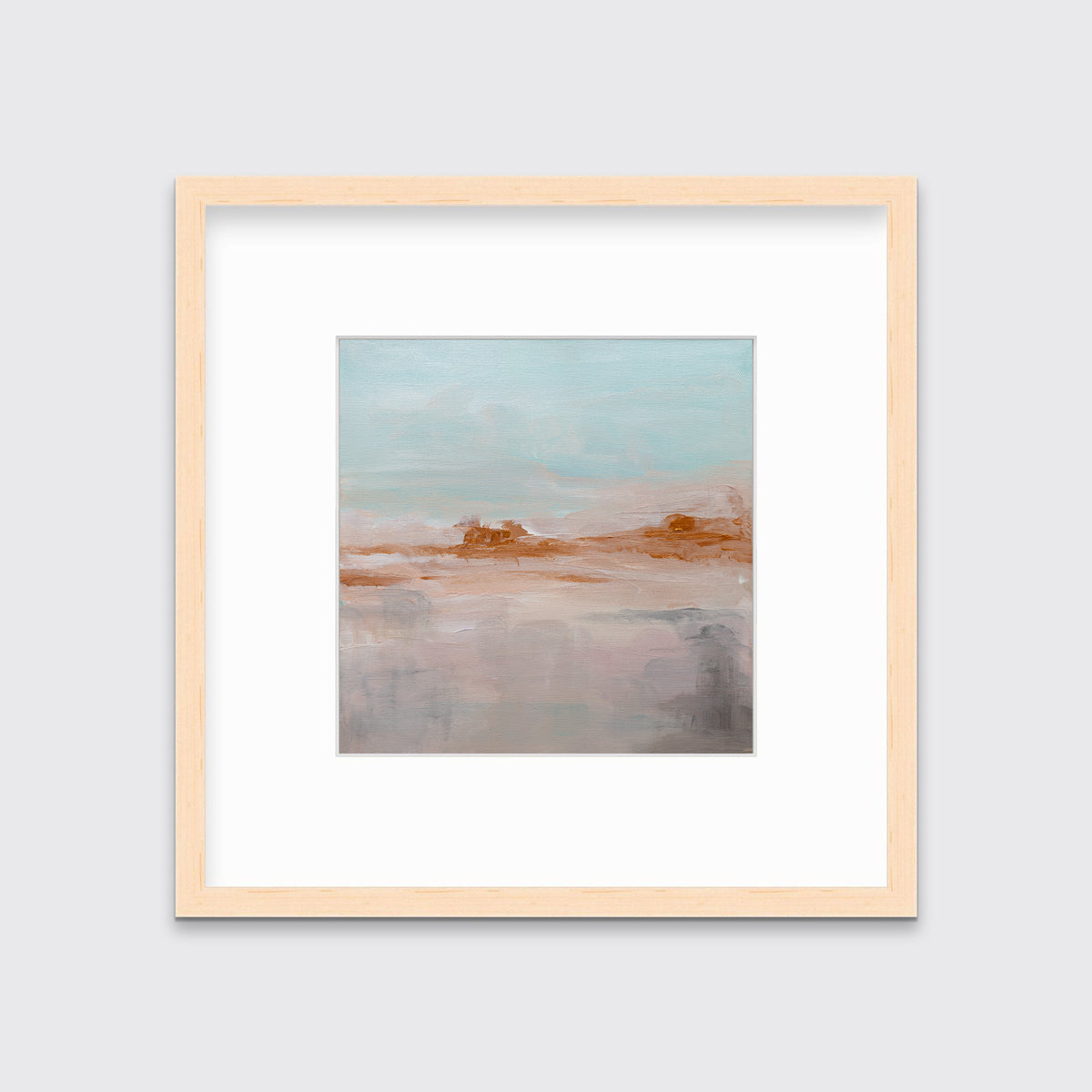 A teal, copper and dusty pink abstract print in a natural wood frame with a mat hangs on a white wall.