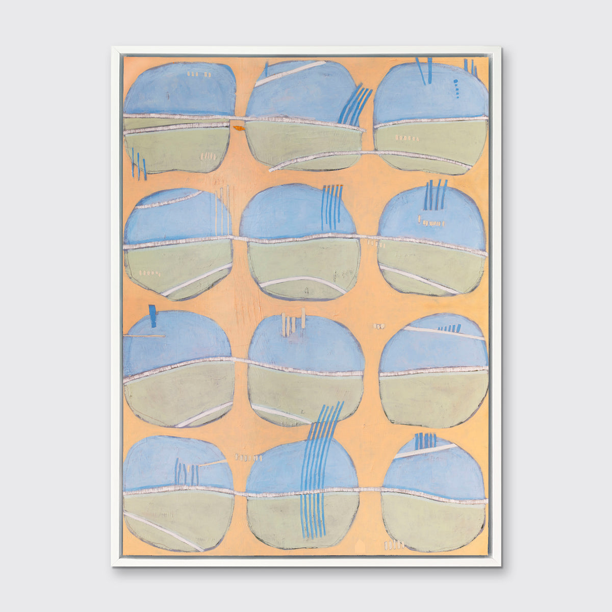 A orange, blue, green and white abstract print in a white floater frame hangs on a white wall.
