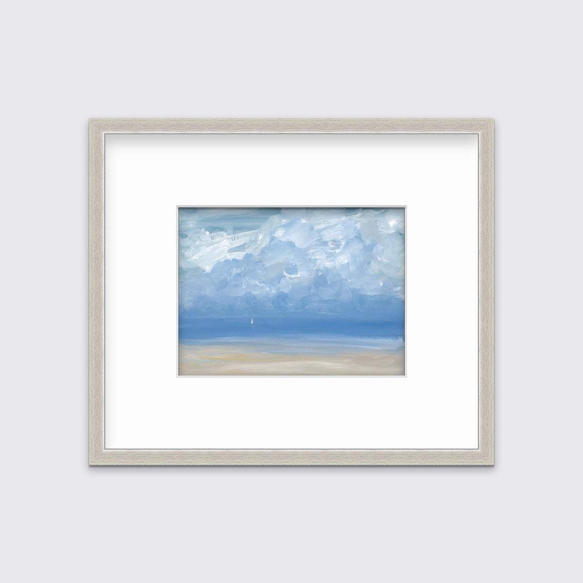 A white, blue and beige abstract seascape print in a silver frame with a mat hangs on a white wall.