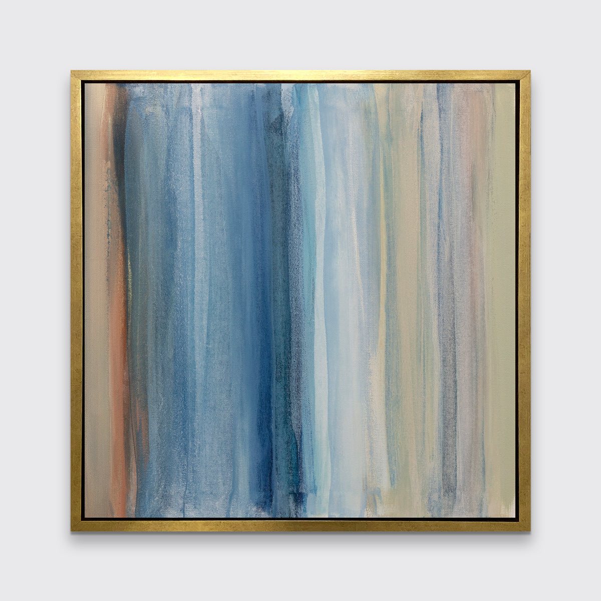 A blue, white, orange and light green abstract print in a gold floater frame hangs on a white wall.