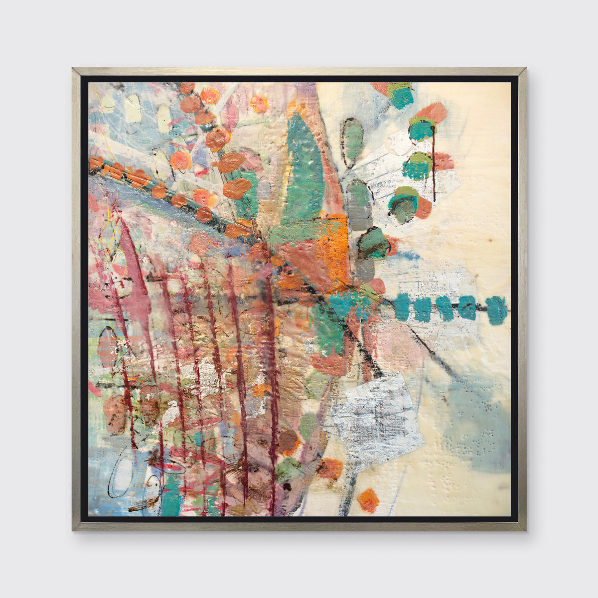 A multicolored abstract print in a silver floater frame hangs on a white wall.