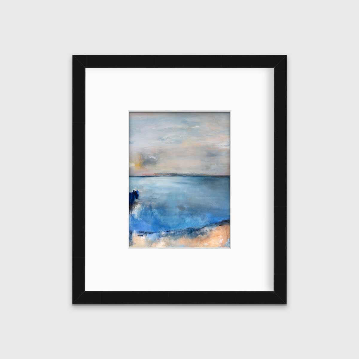 A blue and grey abstract print in a black frame with a mat hangs on a white wall.