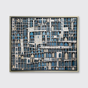 A blue, black, beige and white abstract house print in a silver floater frame hangs on a white wall.