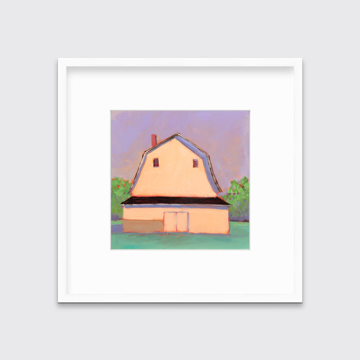 A print of a light orange barn, a lavender sky, green bushes and a teal ground in a white frame with a mat hangs on a white wall.
